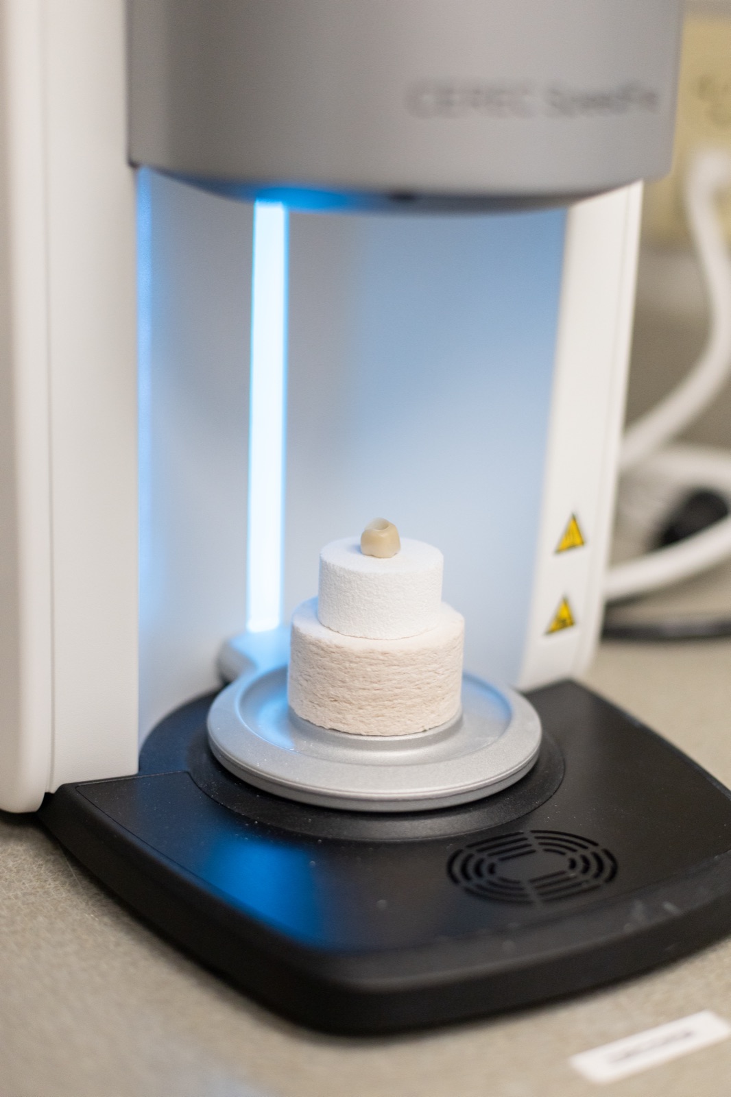 Ceramic being processed in the in-office milling and sintering unit