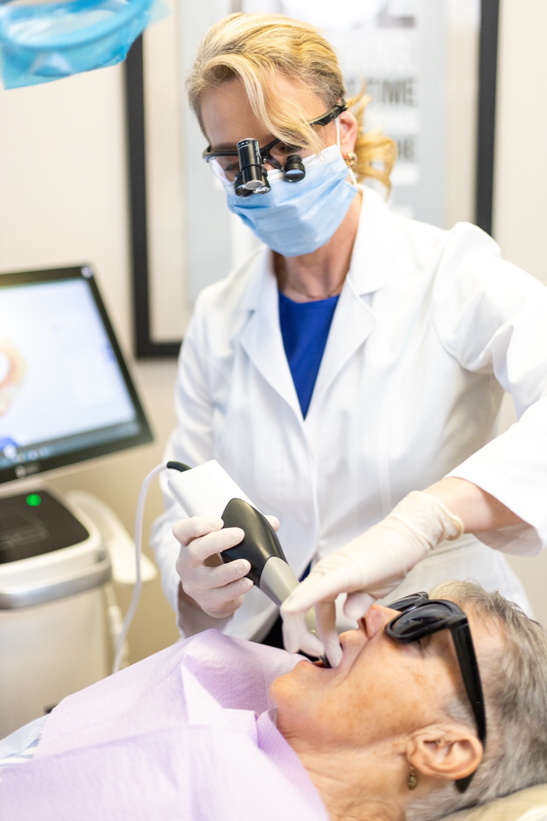 Dr. House using a digital scanner chairside while preparing a crown