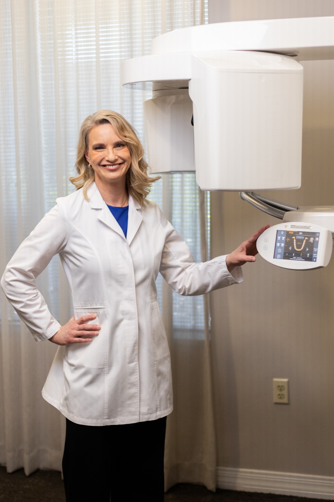 Dr. Allison House beside the cone beam CT imaging scanner