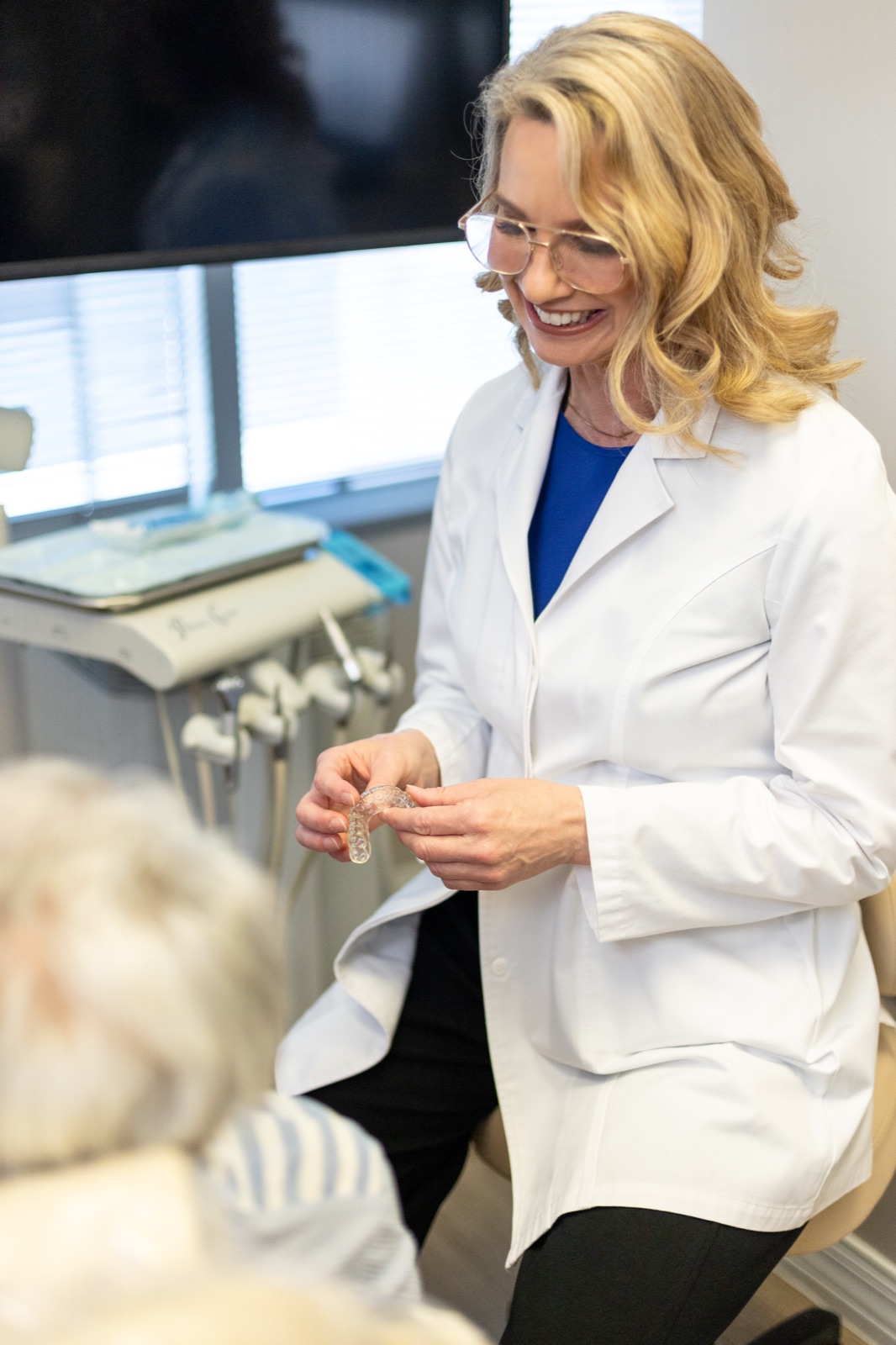 Dr. House showing a patient a removable partial denture during a consultation