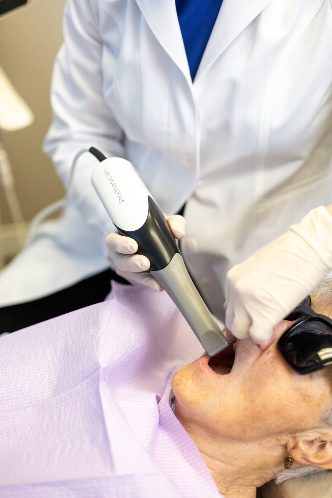 A handheld intraoral scanner capturing a digital impression